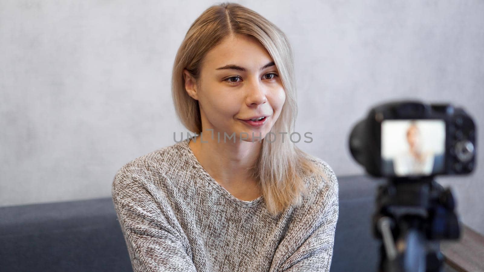 Young and smart. Beautiful young woman in casual wear while recording video blod