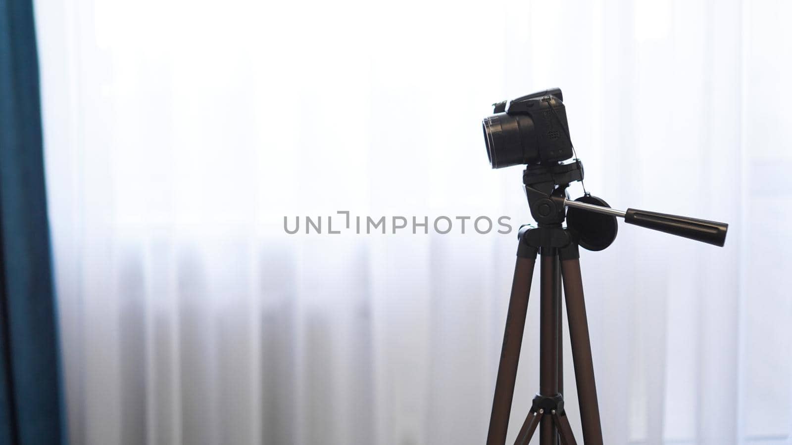 Camera on a tripod indoors. Filming a video blog or photographing at home by natali_brill