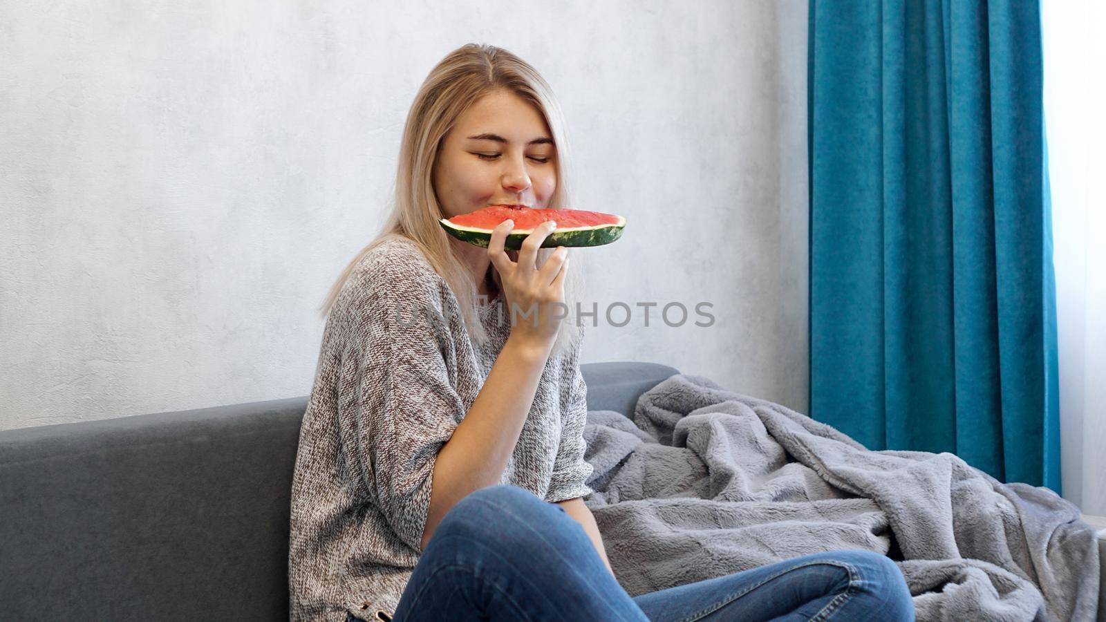 Young attractive woman eating watermelon. Woman at home by natali_brill