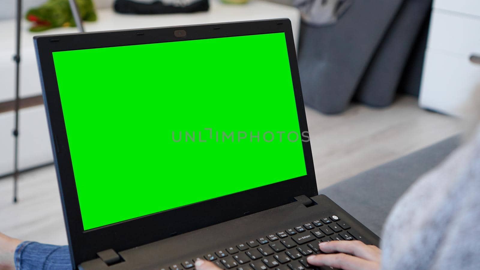 Woman using laptop with green screen. Woman typing on a laptop keyboard by natali_brill