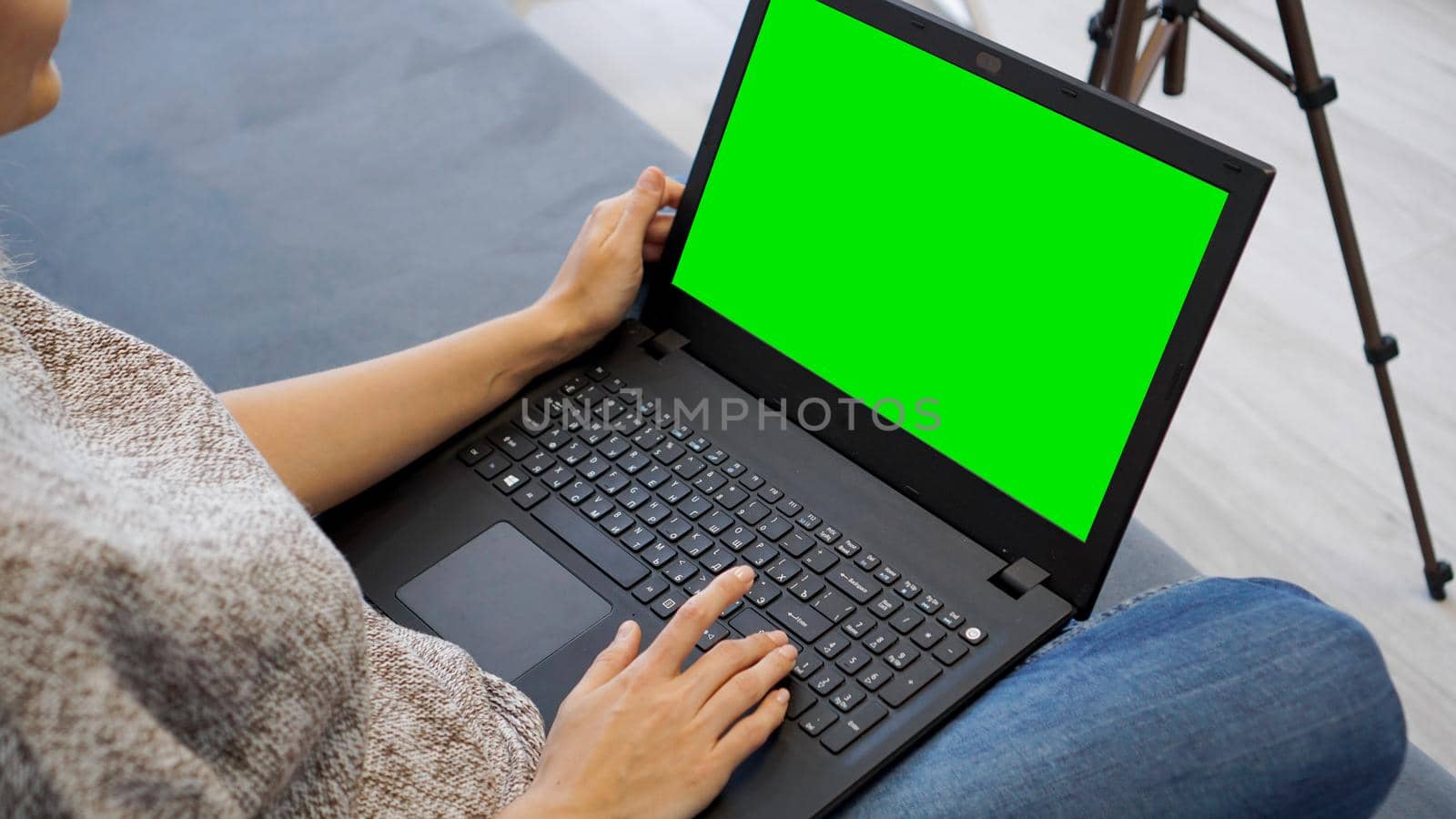 Woman using laptop with green screen. Woman typing on a laptop keyboard by natali_brill