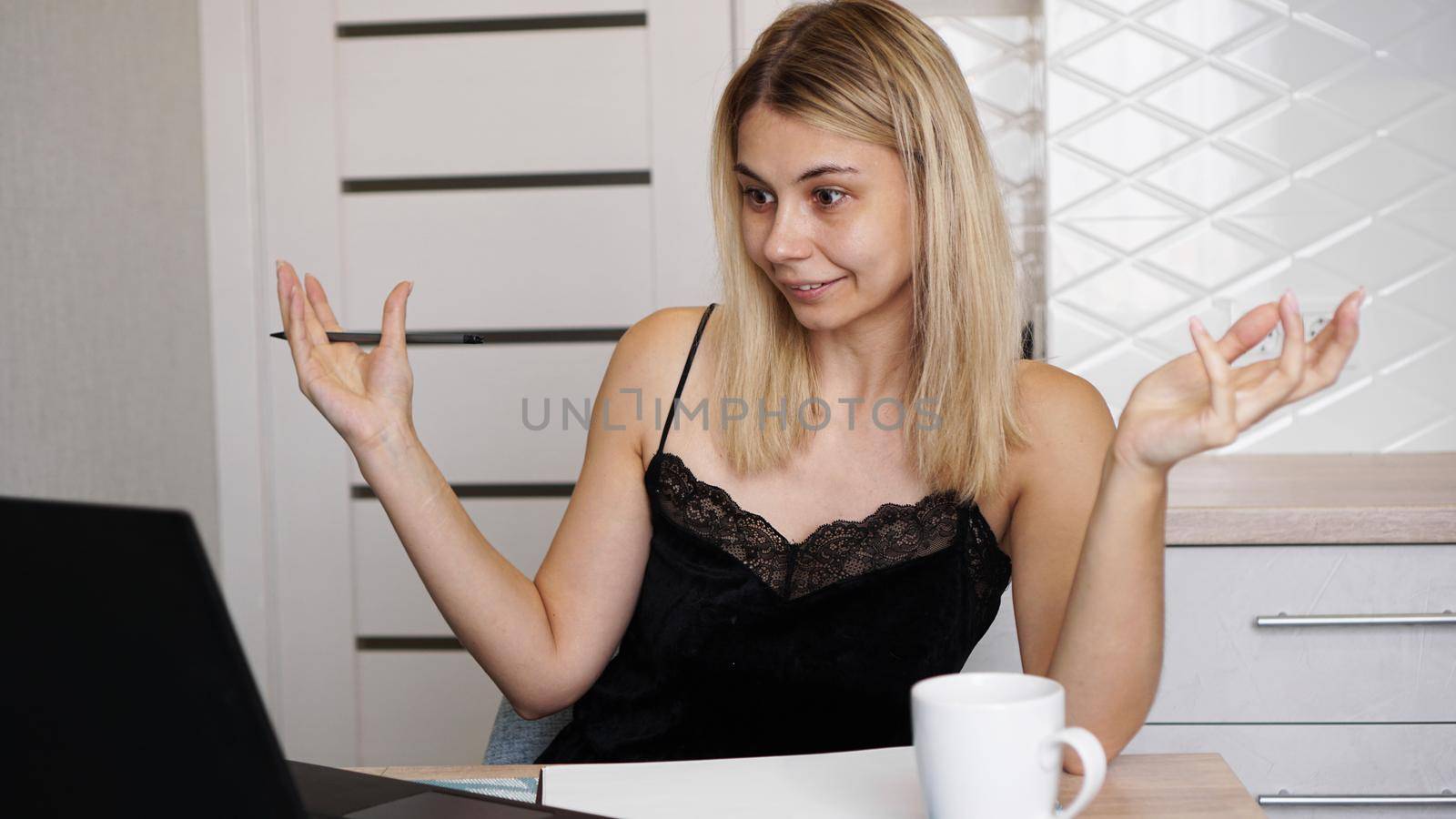 Excited young beautiful woman with arms raised using looking at her laptop screen. Unexpected pleasant good news