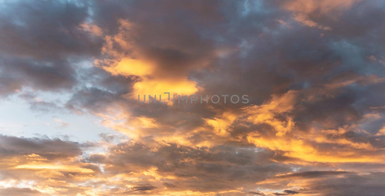 Orange afternoon sun lit on dark blue sunset sky, nature background.