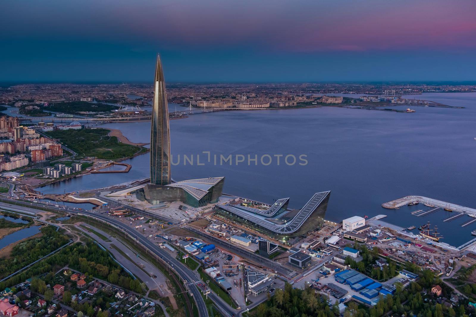 Russia, St.Petersburg, 16 May 2021: Drone point of view of highest skyscraper in Europe Lakhta Center at pink sunset, Headquarters of the oil company Gazprom, stadium Gazprom Arena on background by vladimirdrozdin