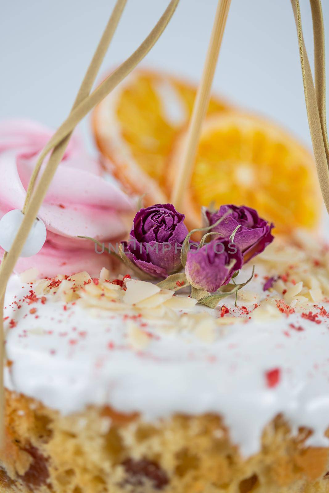 Close-up of an Easter cake. Dried oranges and roses on top of the cake by galinasharapova