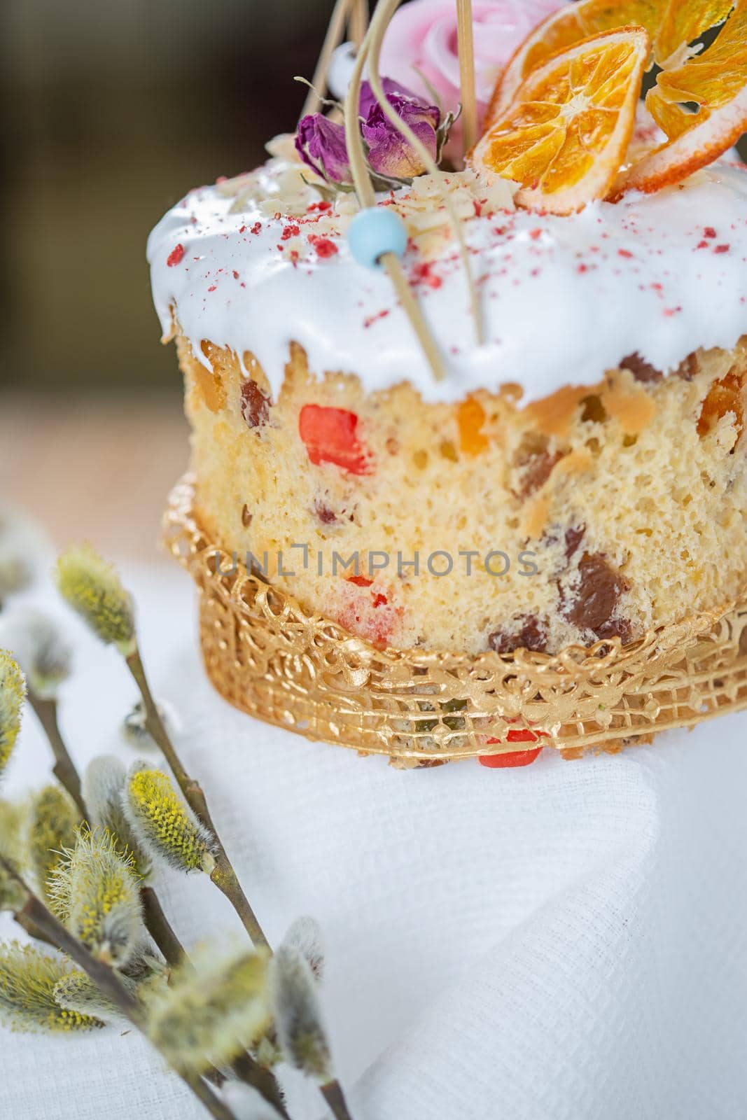 Close-up of an Easter cake. Dried oranges and roses on top of the cake.