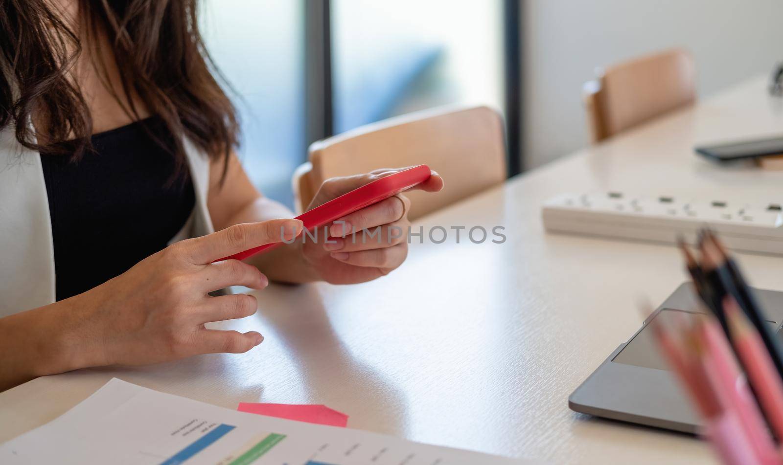 Close up woman use of smart phone with business on working space at home office.