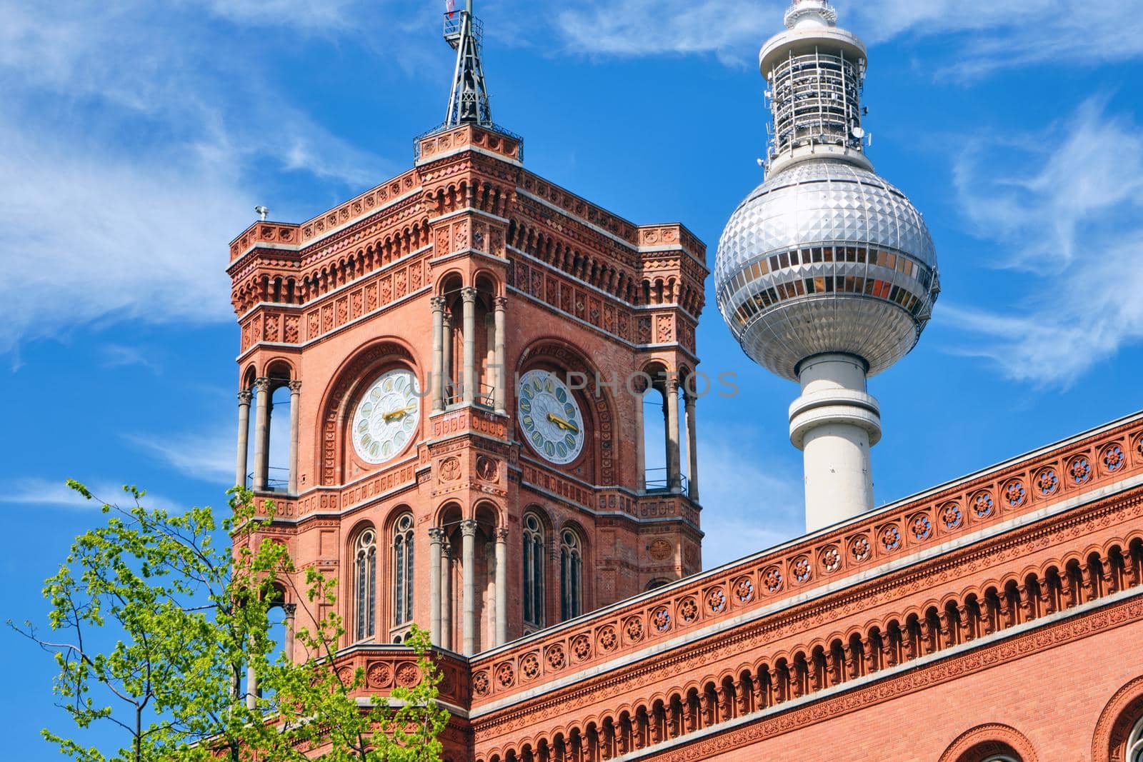 Detail of the tower of the Rotes Rathaus in Berlin with the TV Tower in the back