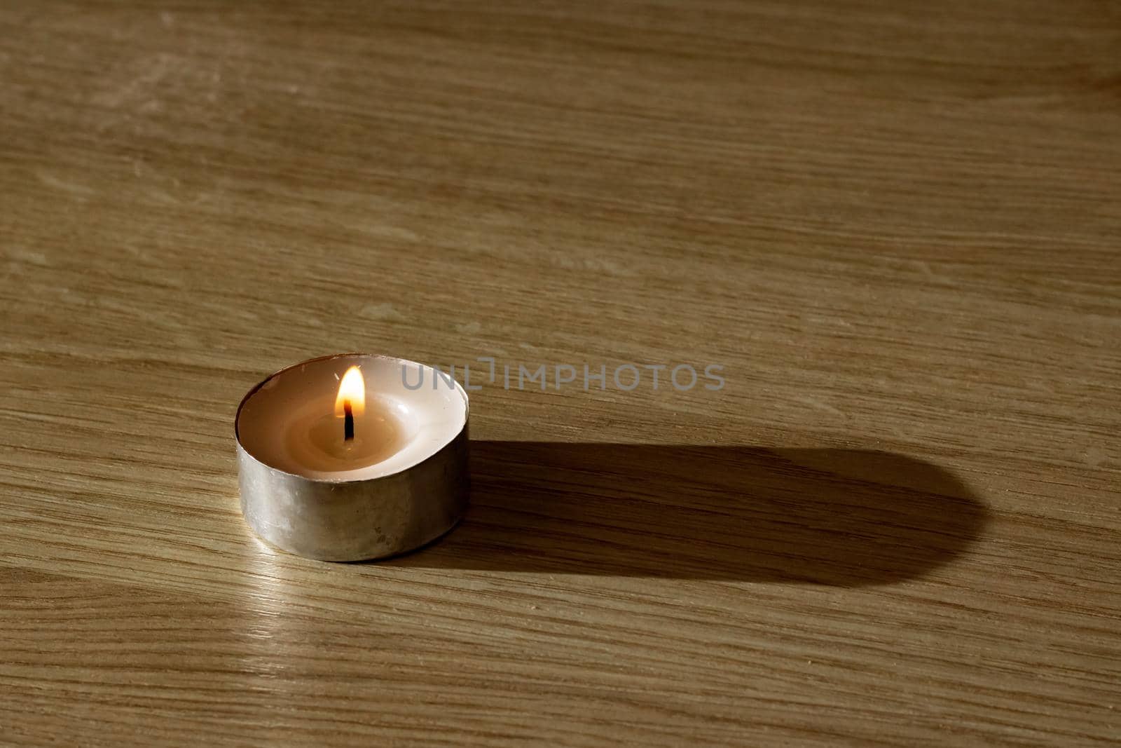 The Little candle on a wooden table with copy space