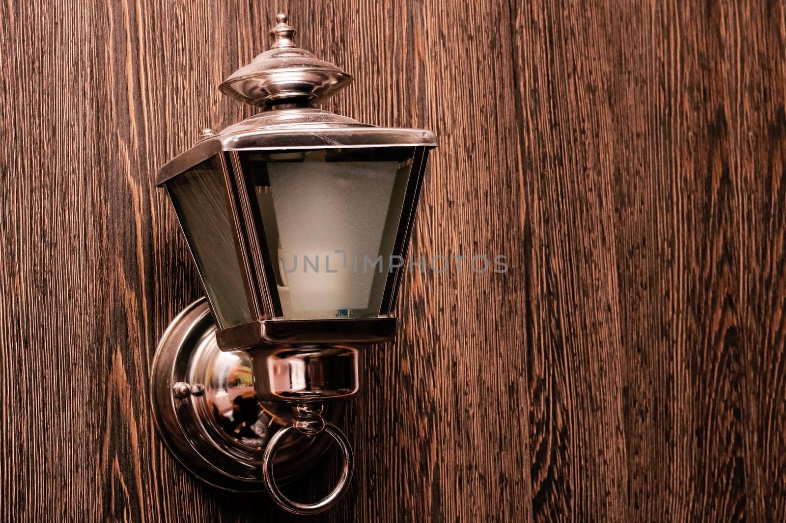 Retro street lamp on a wooden wall with copy space
