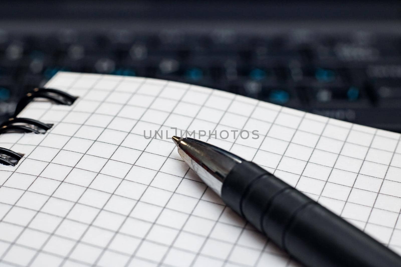 Writing book and pen on a laptop background close up