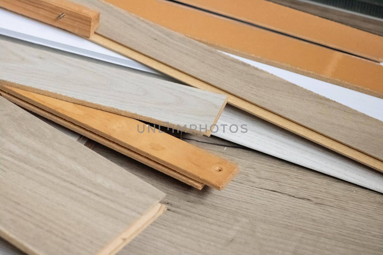 Wooden flooring boards close up, construction waste, background