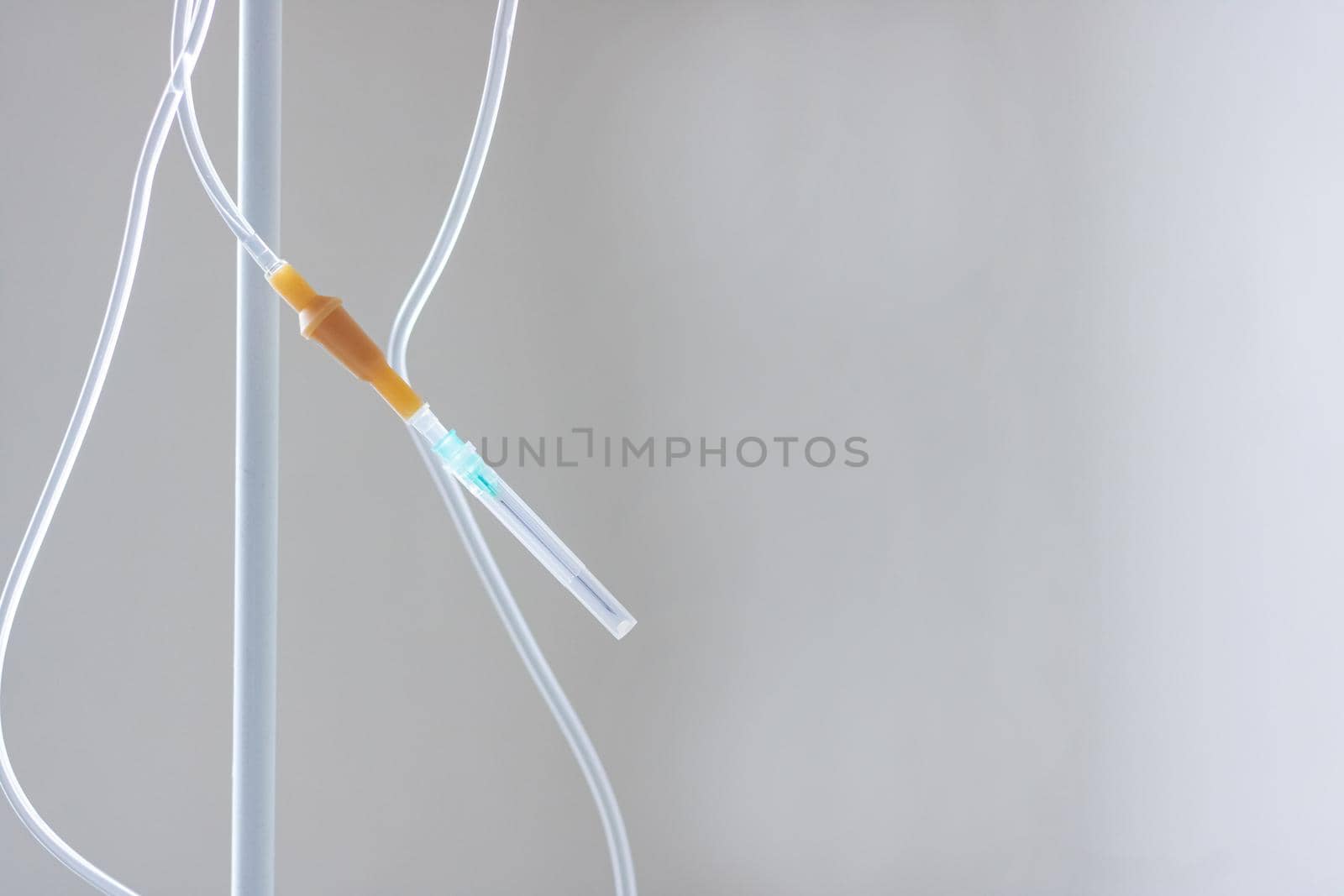 Intravenous drug system close up on gray background, copy space