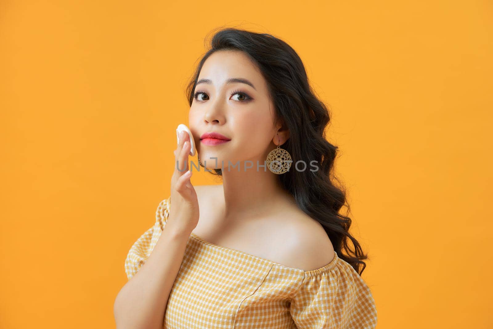 Portrait of beautiful asian woman applying powder puff at cheek makeup of cosmetic, beauty of girl with face smile isolated 