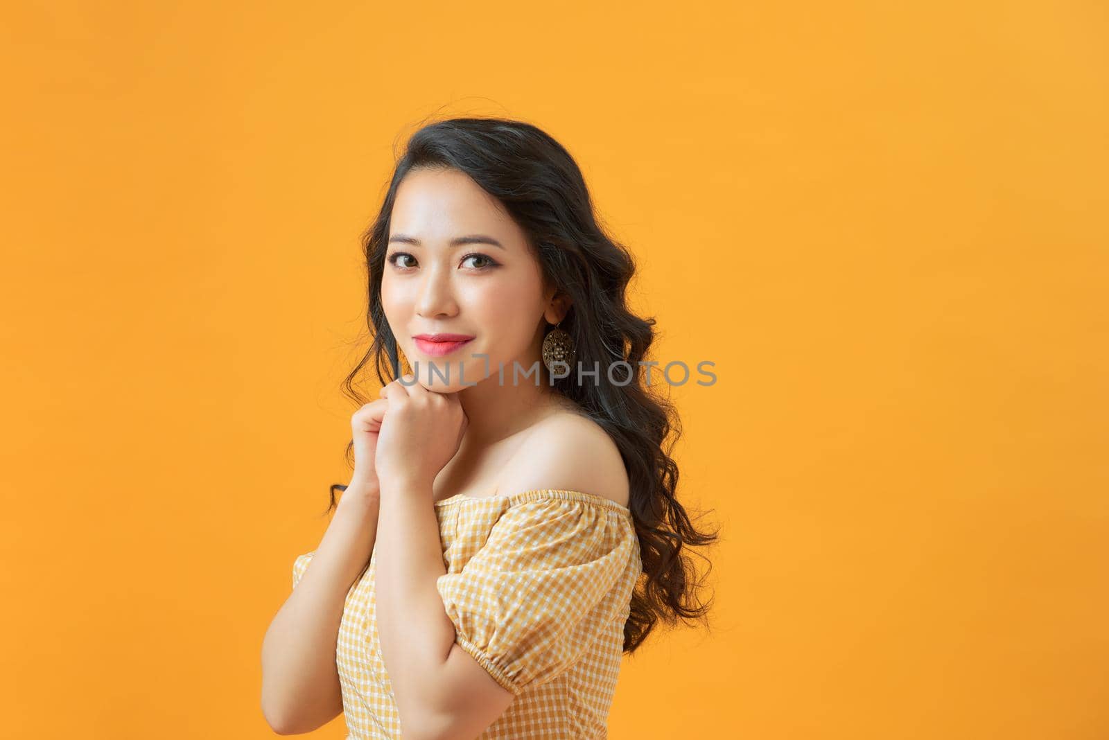 Close up photo of choosing girl making up her mind about something while isolated with yellow background