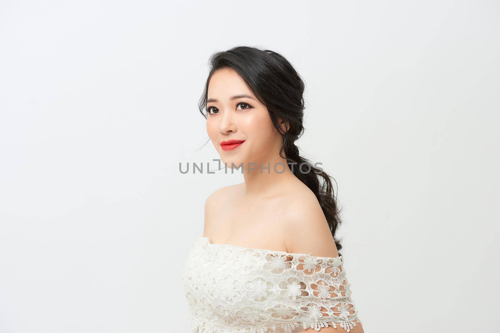Young bride in a luxurious white wedding dress and beautiful hair. 
