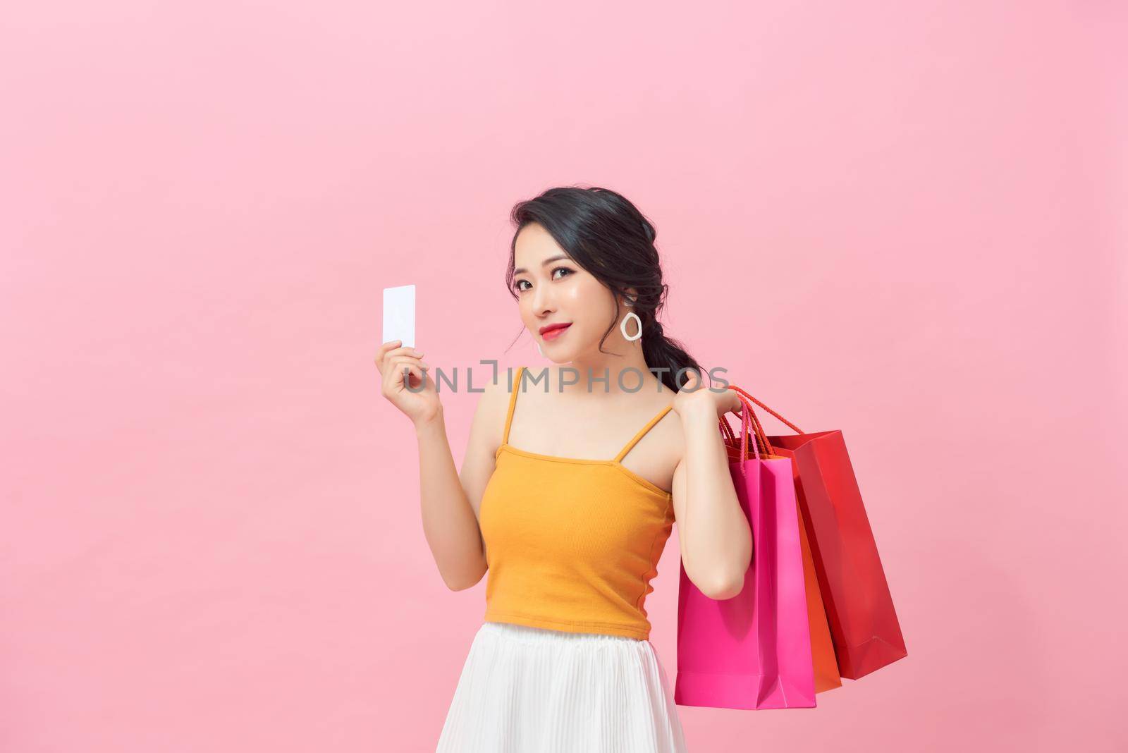 Women are shopping In the summer sale, she is using a credit card and enjoys shopping. by makidotvn