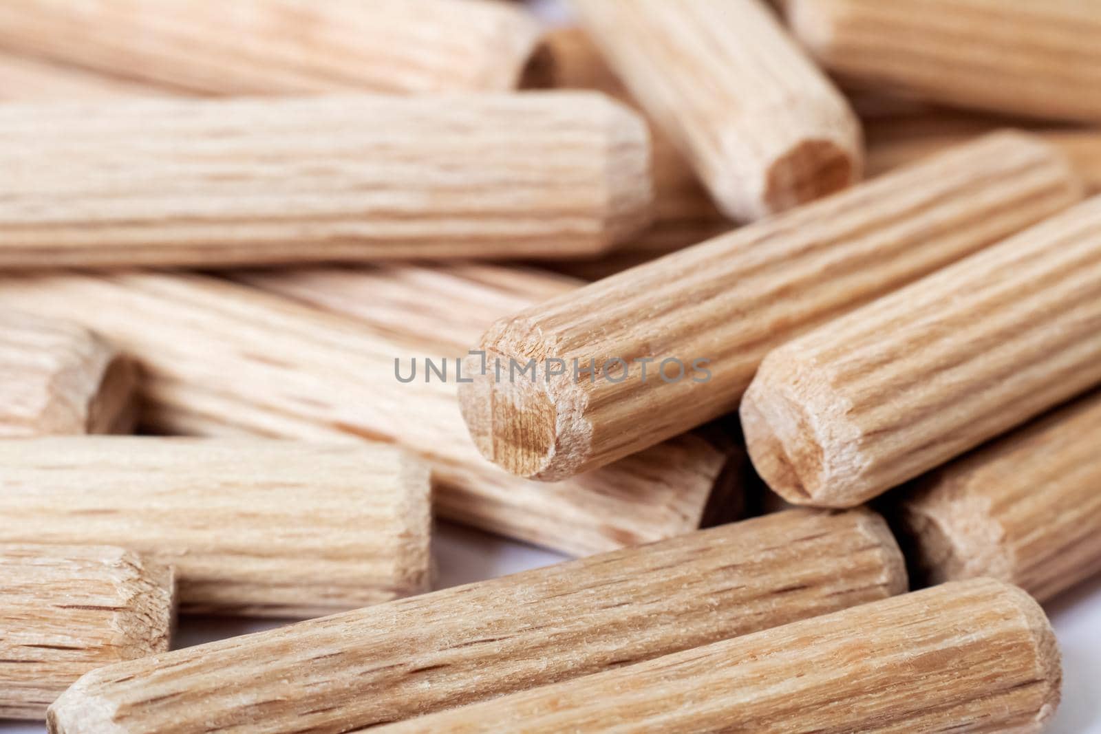 Wooden dowels in a heap close up, macro photo