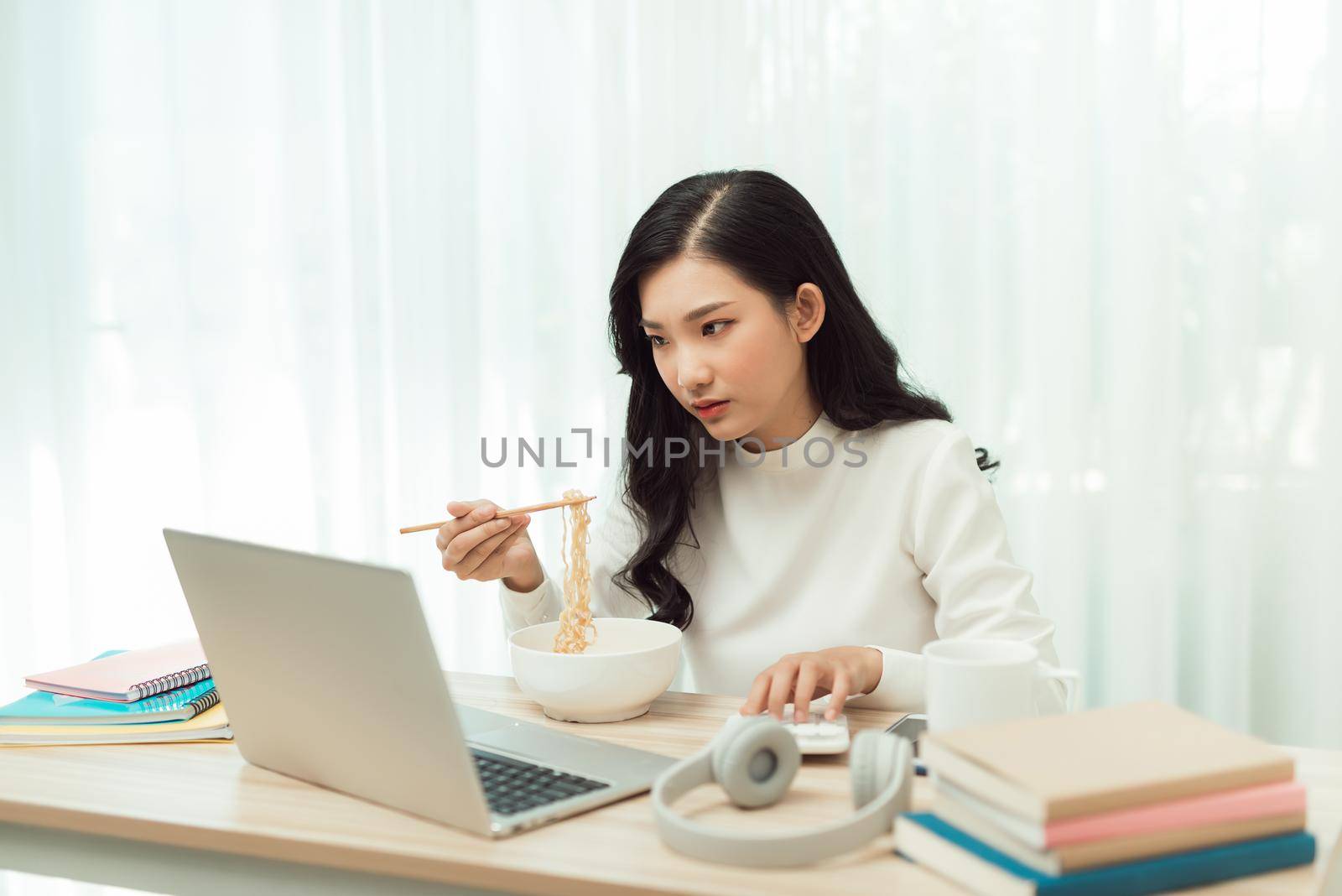 Young Asian girl sitting on desk work overtime, enjoy relax time.female working . by makidotvn