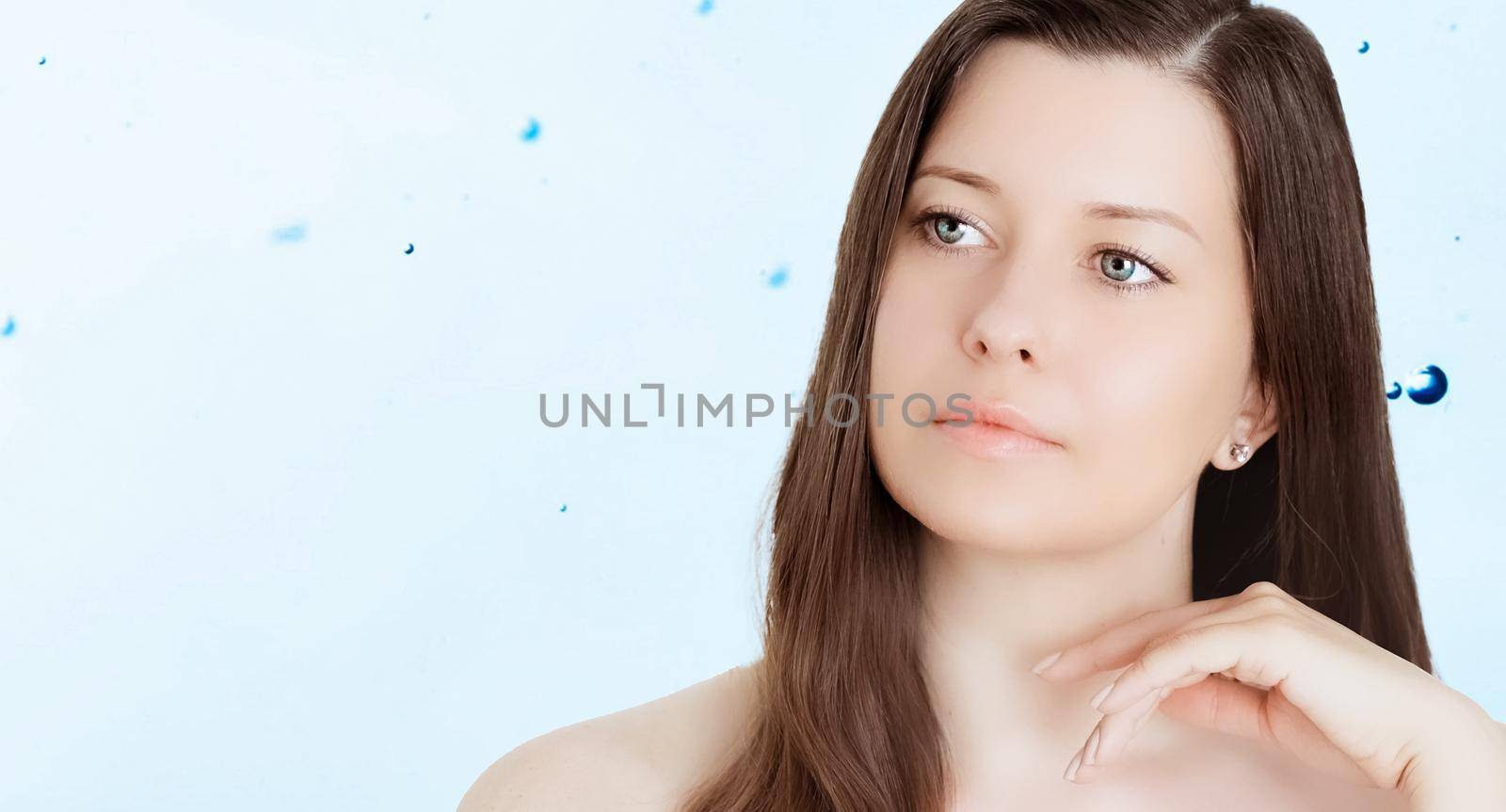 Rejuvenation skincare and beauty ad, beauty face portrait of young woman with healthy clean skin, blue cosmetic liquid drops on background.