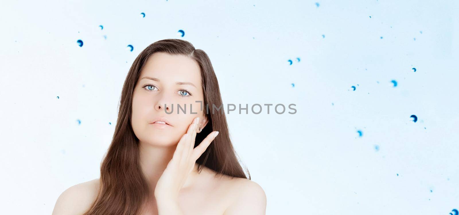 Rejuvenation skincare and beauty ad, beauty face portrait of young woman with healthy clean skin, blue cosmetic liquid drops on background.