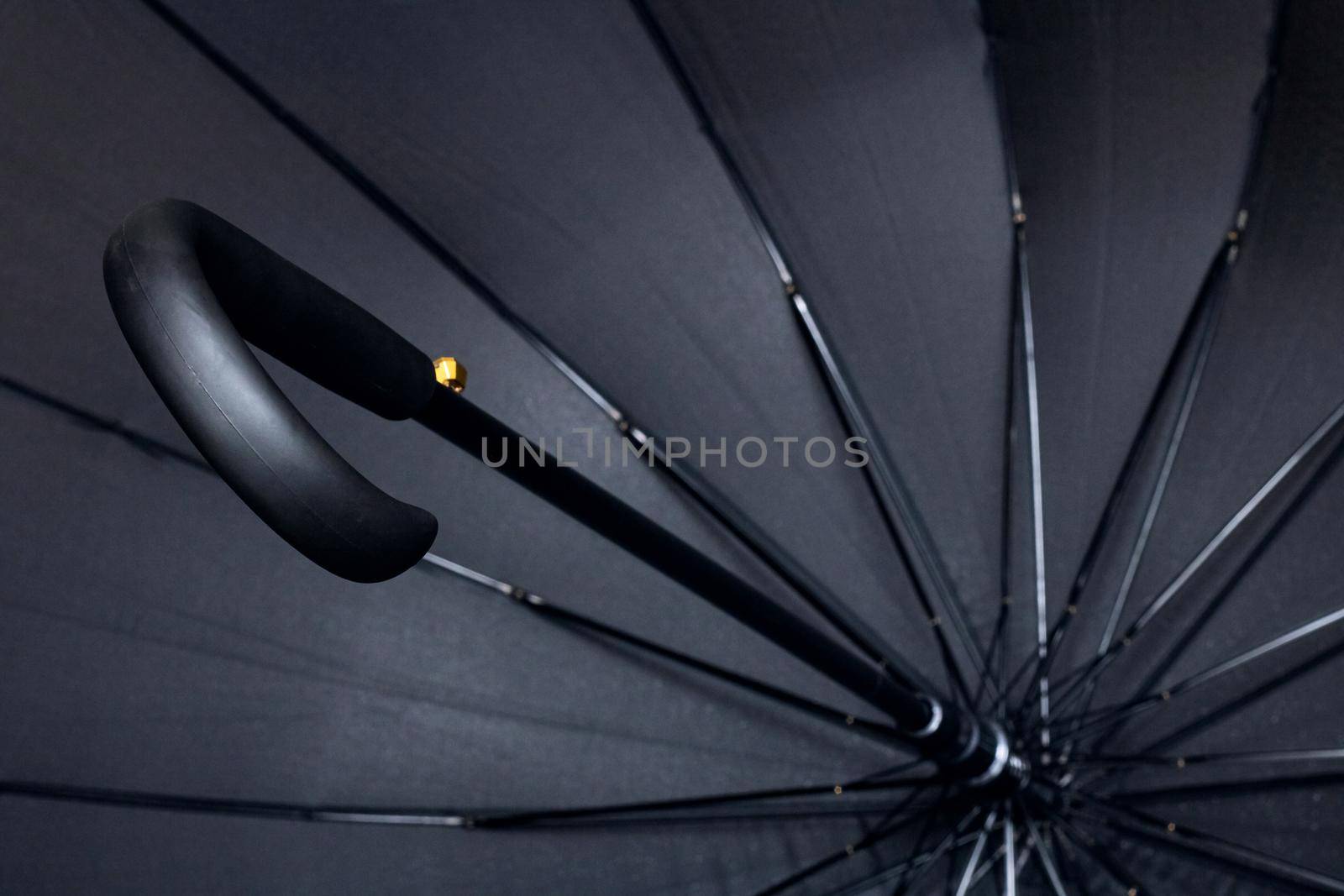 Big black umbrella bottom view close up, with copy space