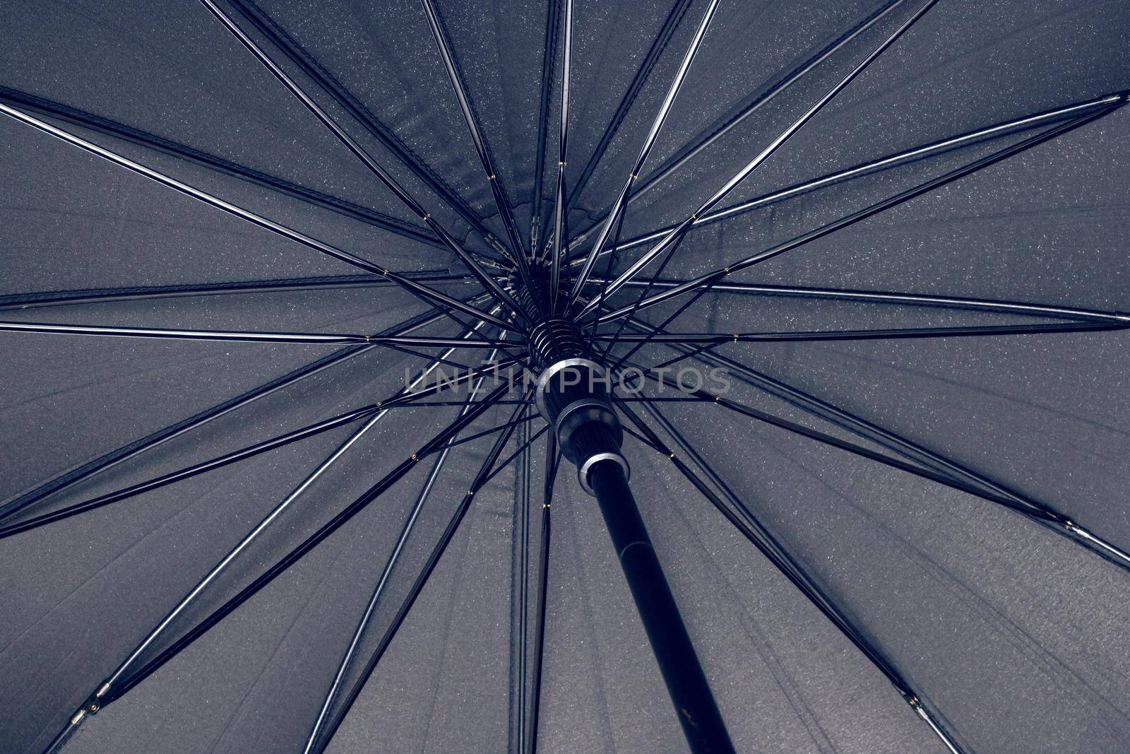 Big black umbrella bottom view close up, with copy space