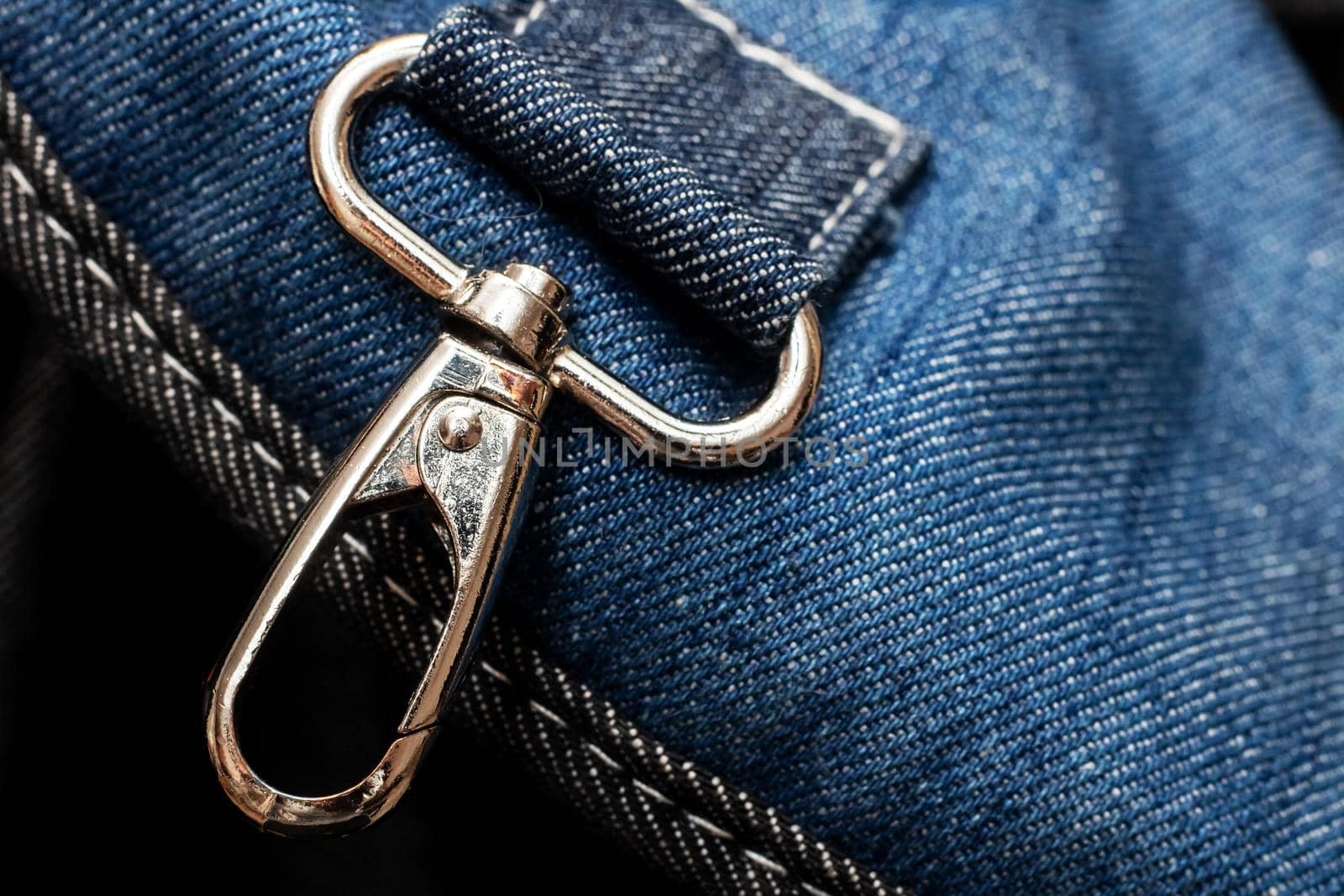 Metal buckle on a blue denim backpack close up by Vera1703