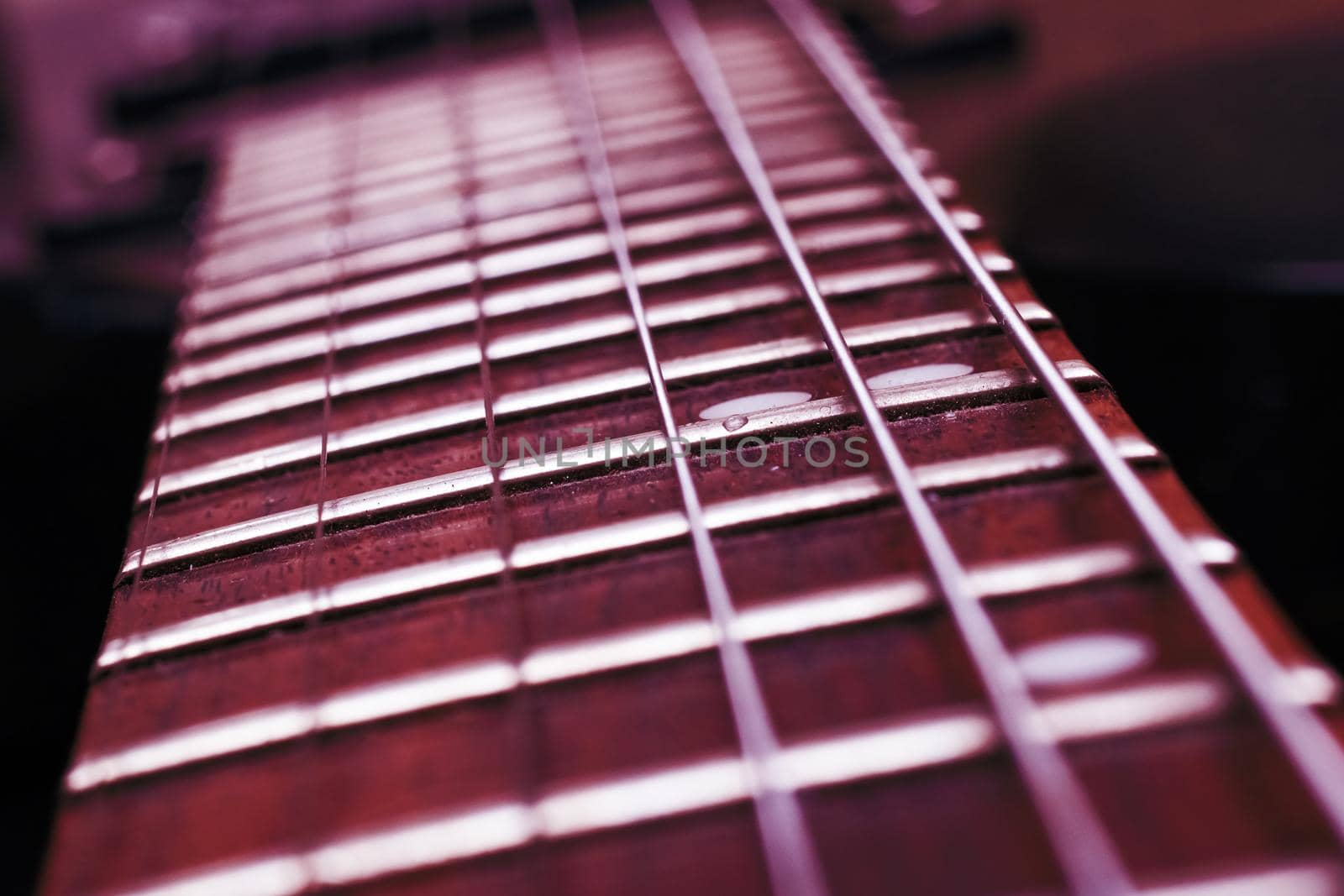 Strings on a red guitar close up, macro photo