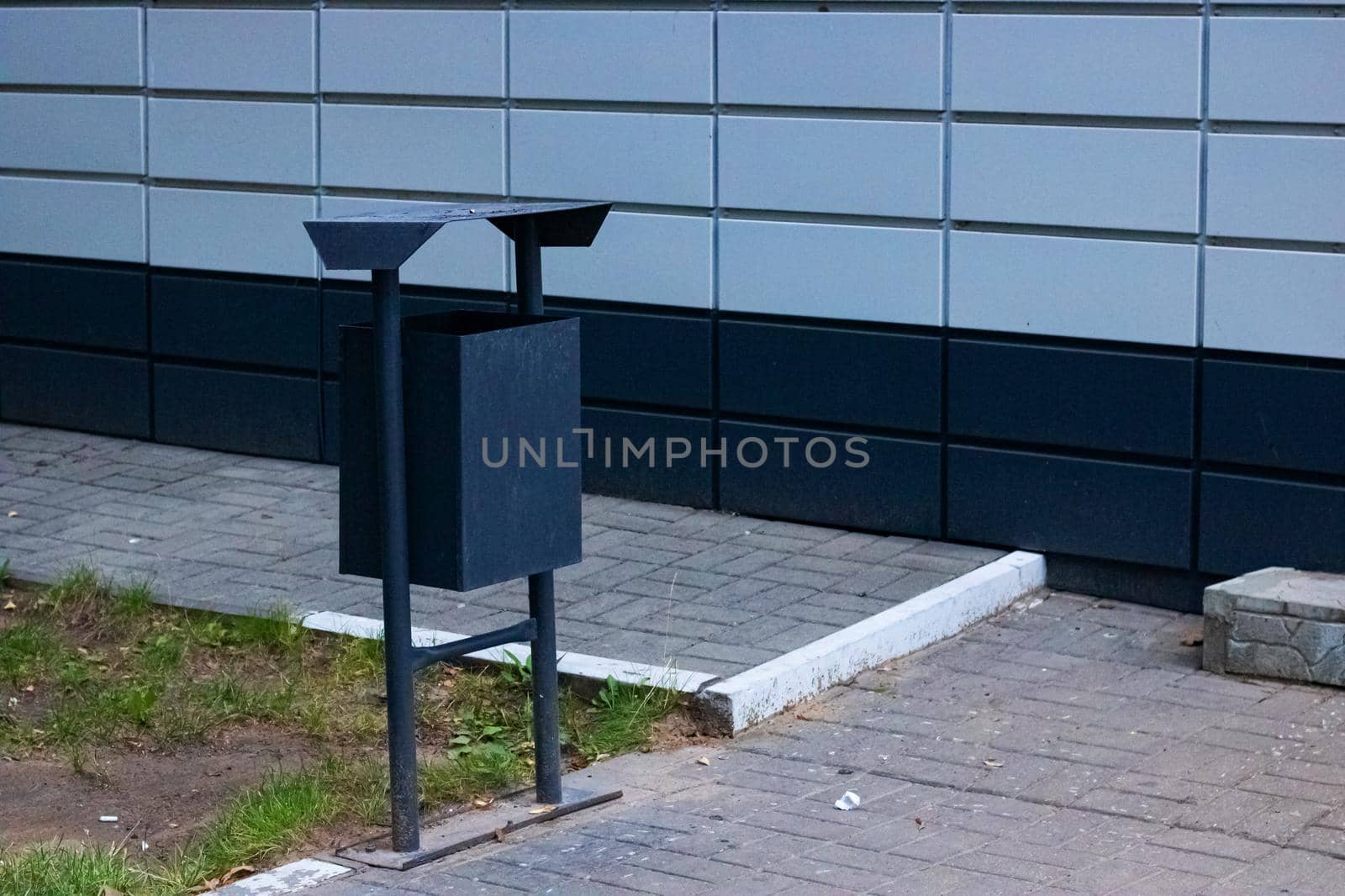 Garbage can at the corner of a building close-up, copy space