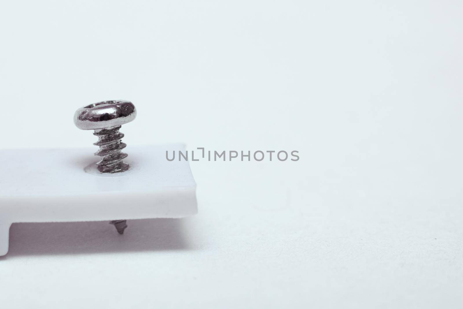 Screw twisted in white device close up by Vera1703