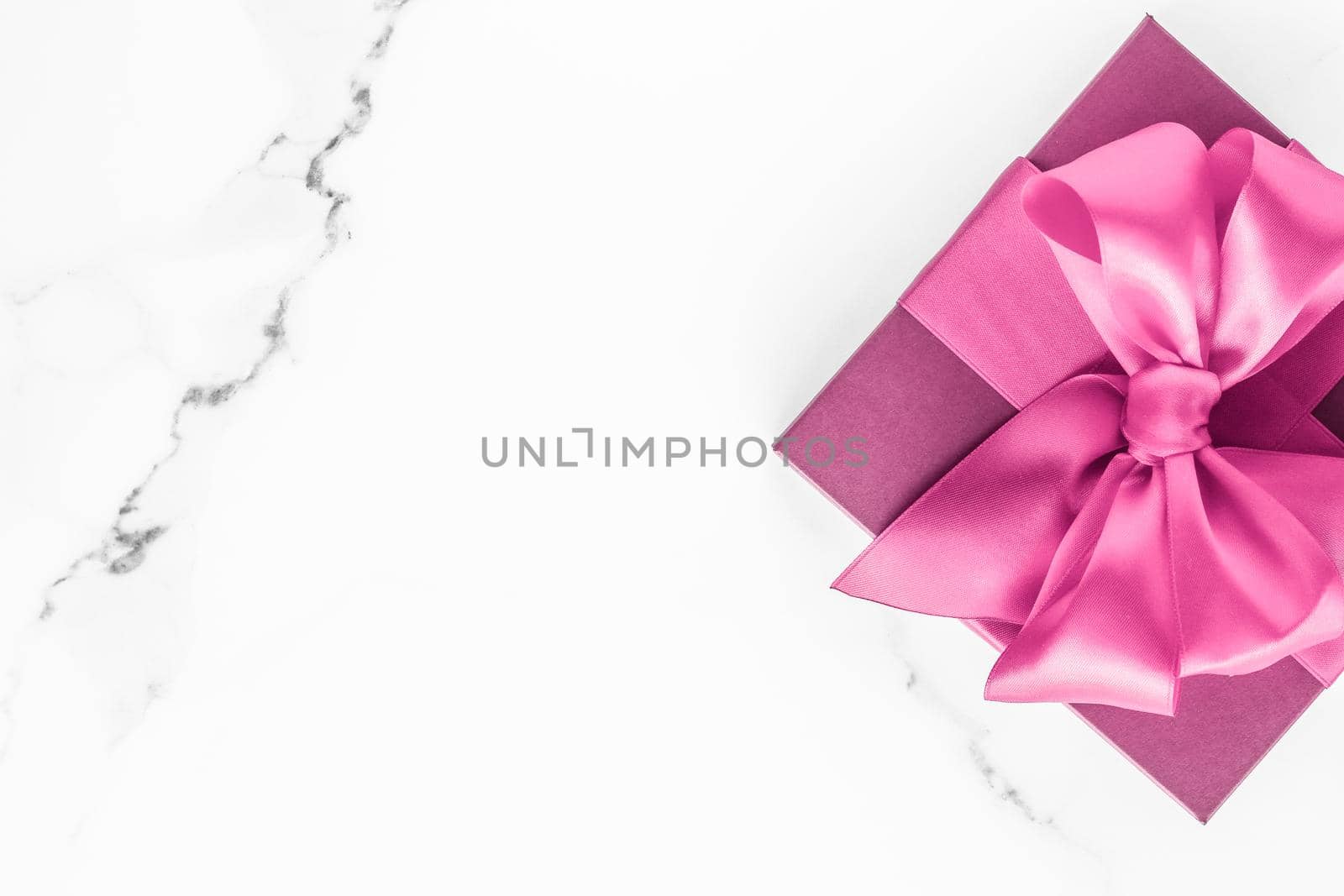 Birthday, wedding and girly branding concept - Pink gift box with silk bow on marble background, girl baby shower present and glamour fashion gift for luxury beauty brand, holiday flatlay art design