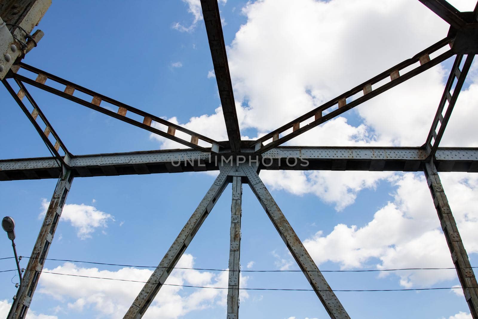 Metal beams on the sky with clouds background close up