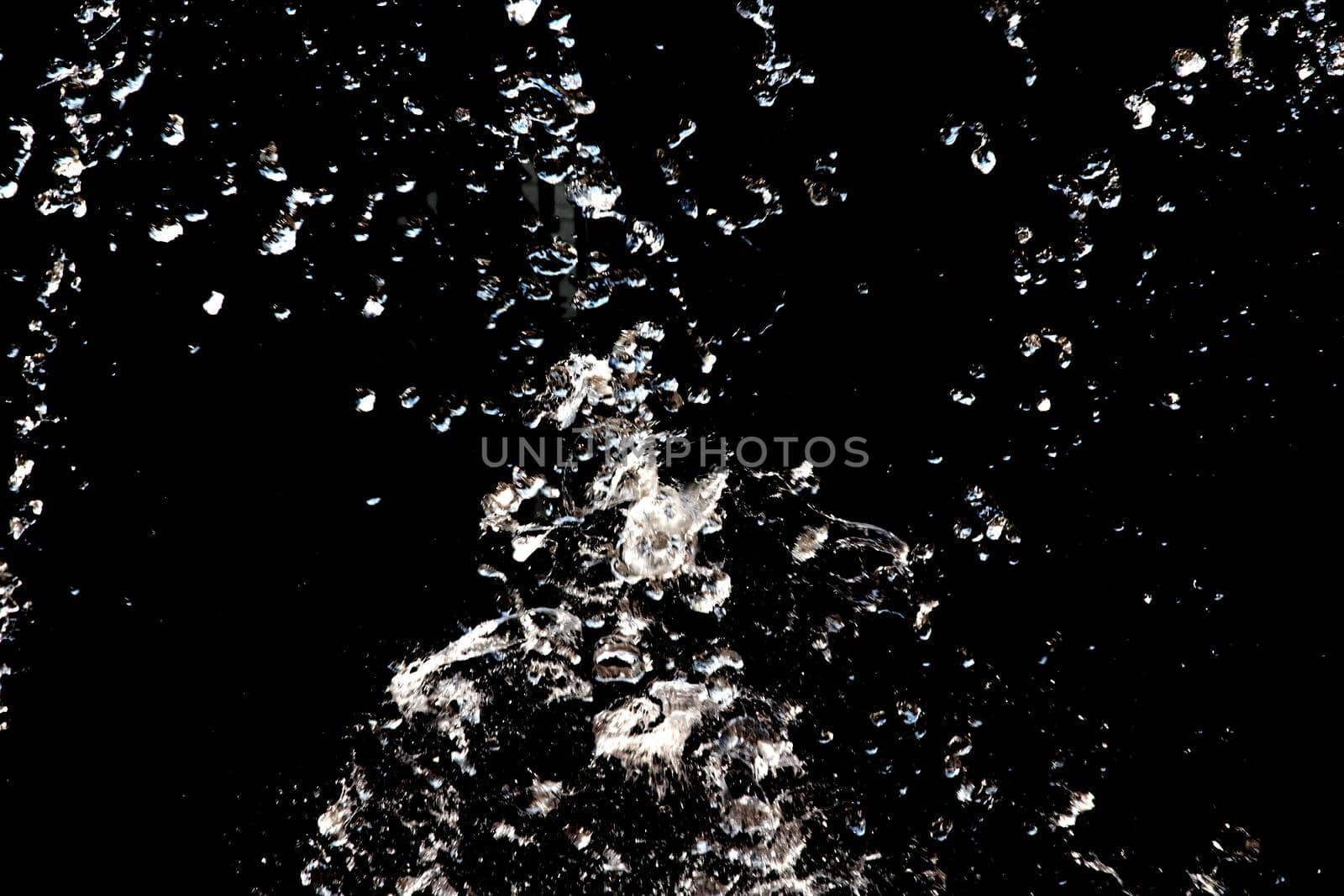 Water splash on a black background close up, copy space