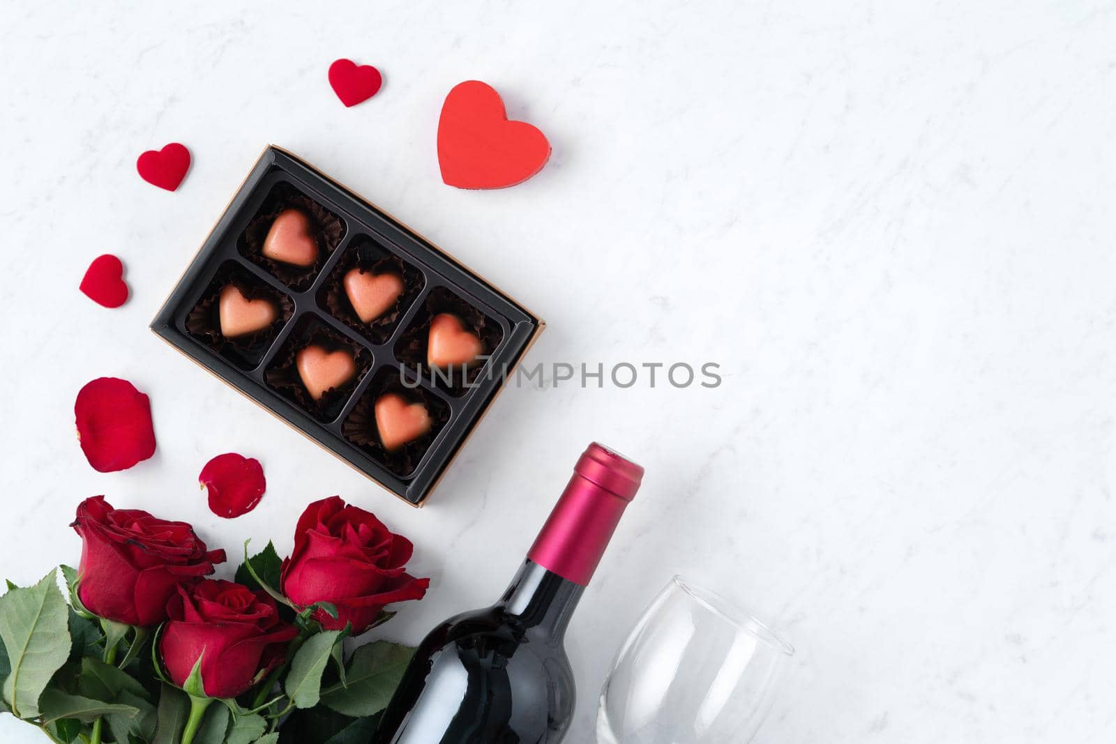 Top view of Valentine day chocolate with rose and wine, festive gift design concept for special holiday dating.