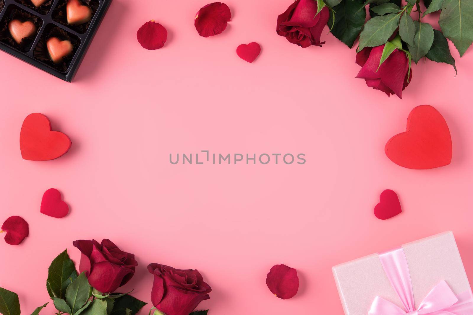 Valentine's Day design concept background with rose flower and gift box on pink background