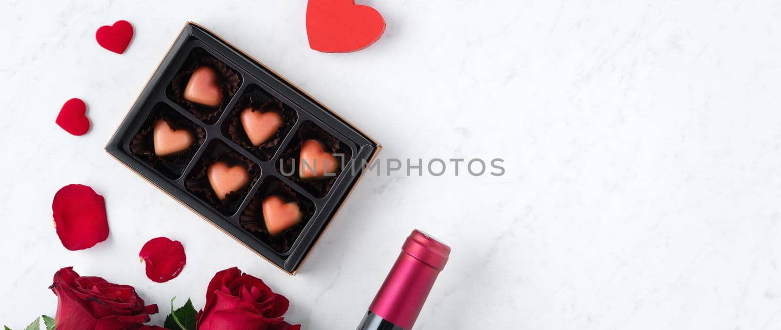 Top view of Valentine day chocolate with rose and wine, festive gift design concept by ROMIXIMAGE