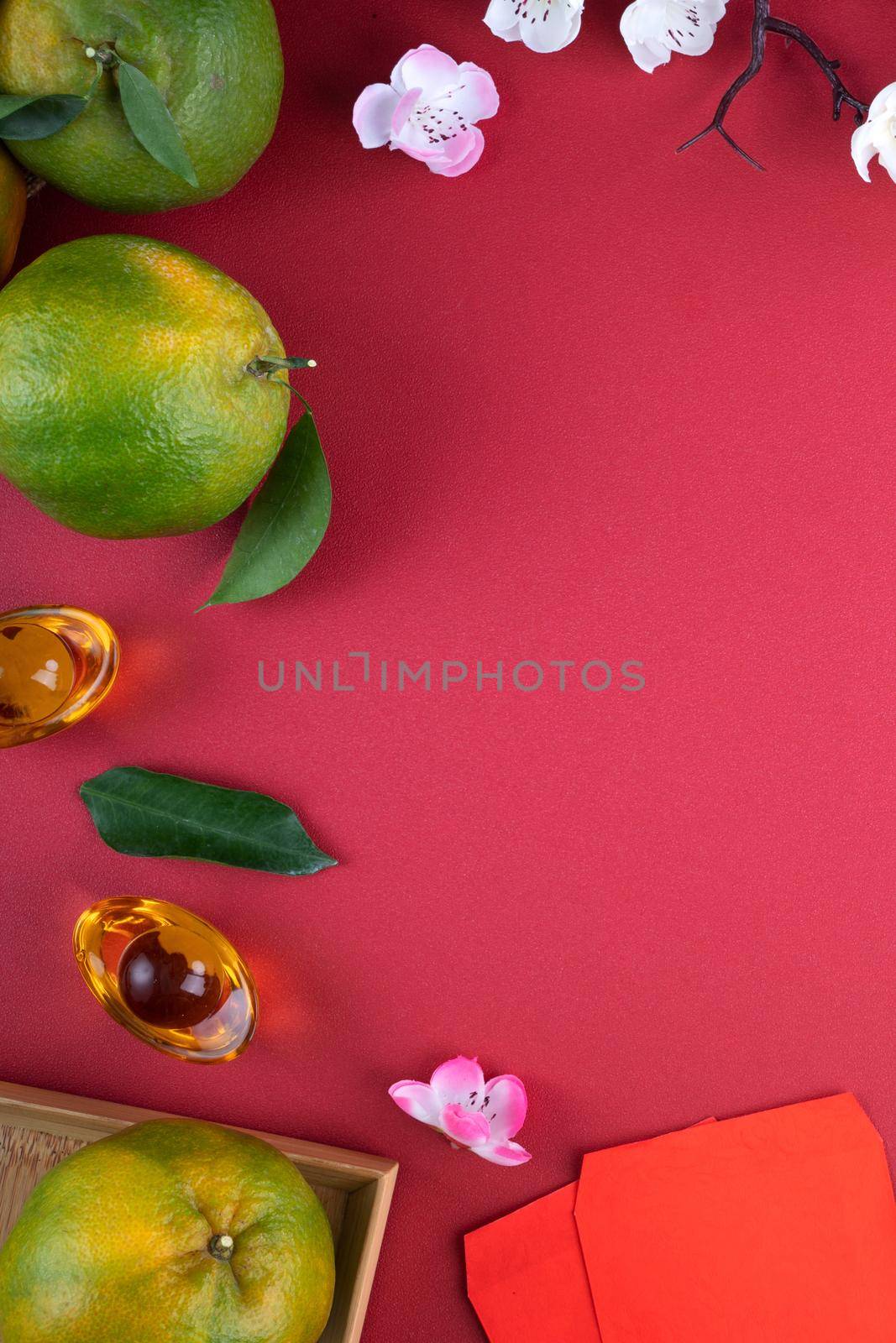 Top view of fresh ripe tangerine mandarin orange with fresh leaves on red table background for Chinese lunar new year fruit concept, the Chinese word means spring.