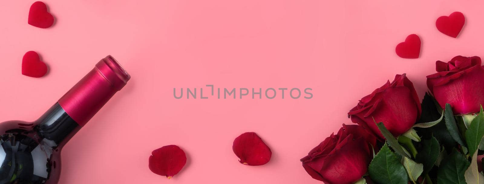 Valentine's Day dating gift with wine and rose concept on pink background by ROMIXIMAGE