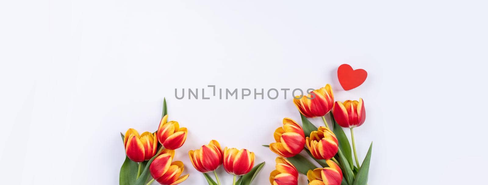 Mother's Day, Valentine's Day background, tulip flower bunch - Beautiful Red, yellow bouquet isolated on white table, top view, flat lay, mock up design concept.