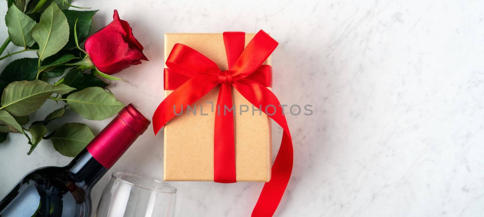 Top view of Valentine day gift with rose and wine, festive meal design concept by ROMIXIMAGE