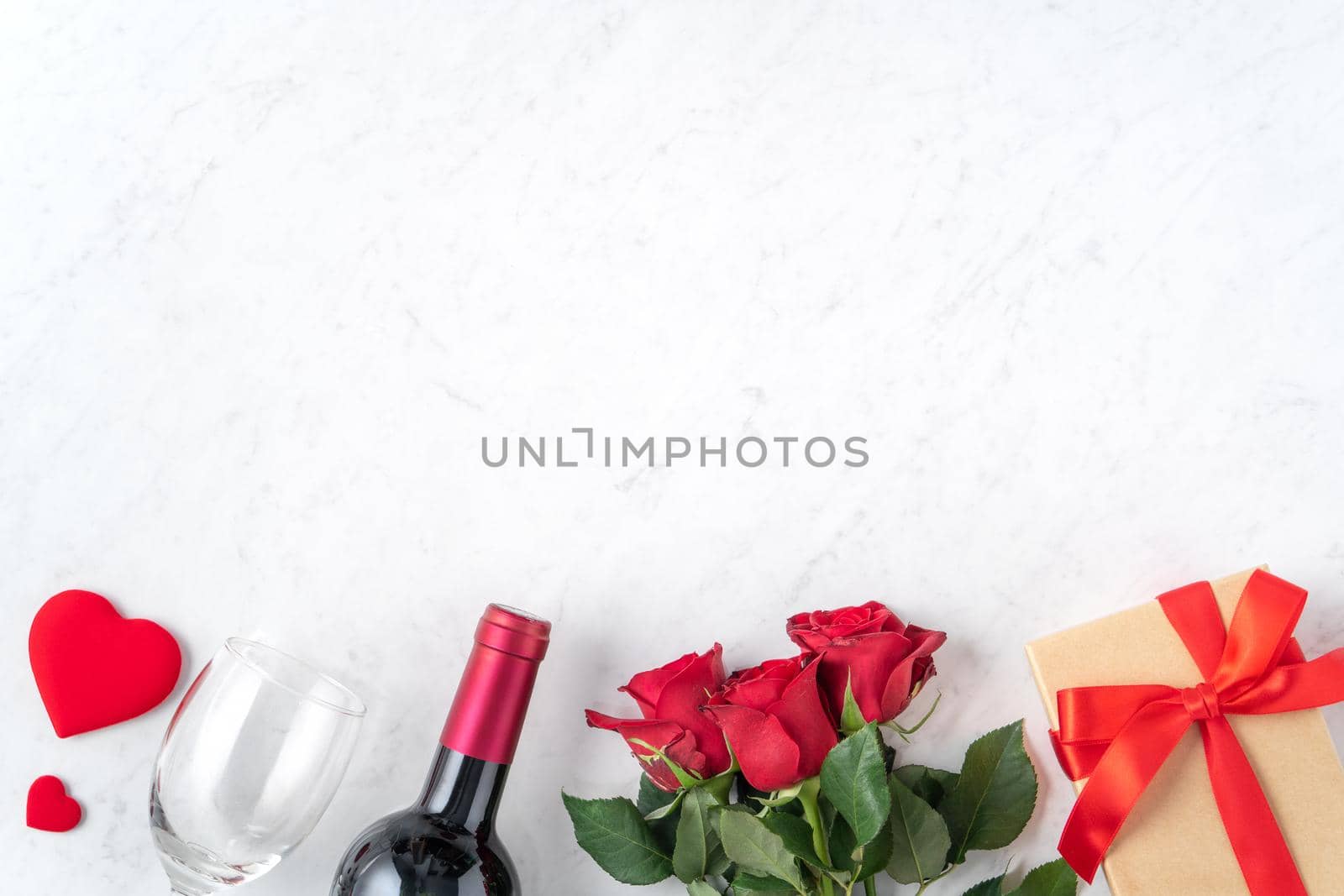 Top view of Valentine day gift with rose and wine, festive design concept for special holiday dating meal.