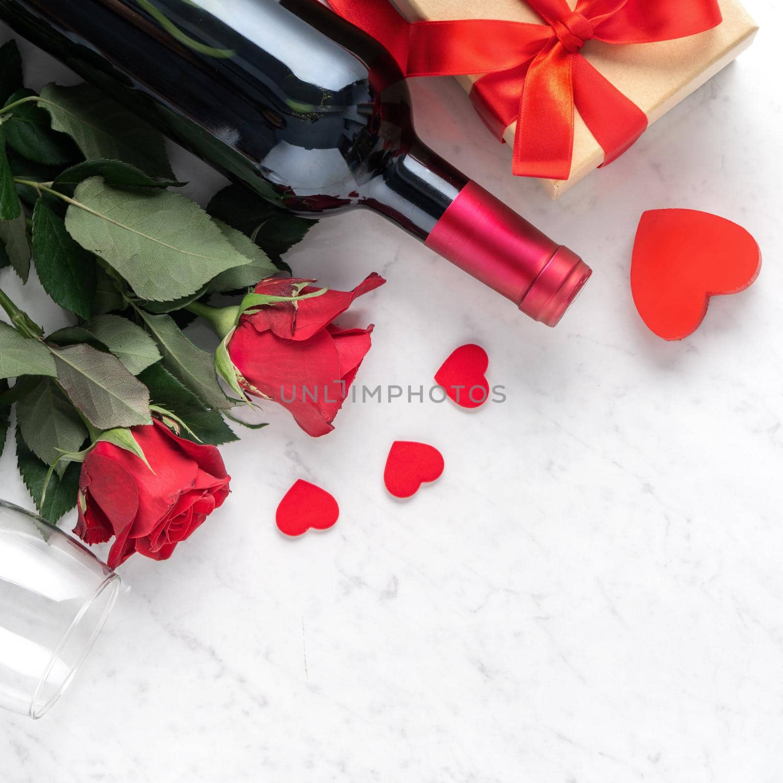 Top view of Valentine day gift with rose and wine, festive design concept for special holiday dating meal.