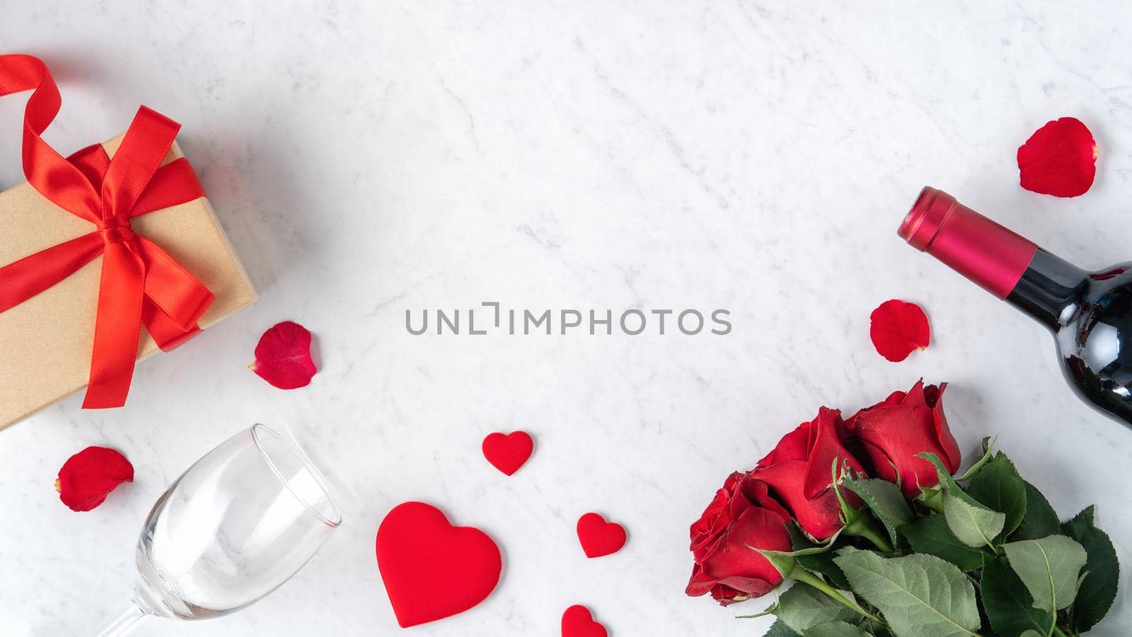 Top view of Valentine day gift with rose and wine, festive design concept for special holiday dating meal.