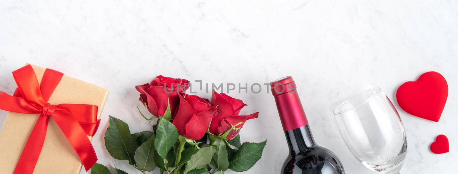 Top view of Valentine day gift with rose and wine, festive design concept for special holiday dating meal.