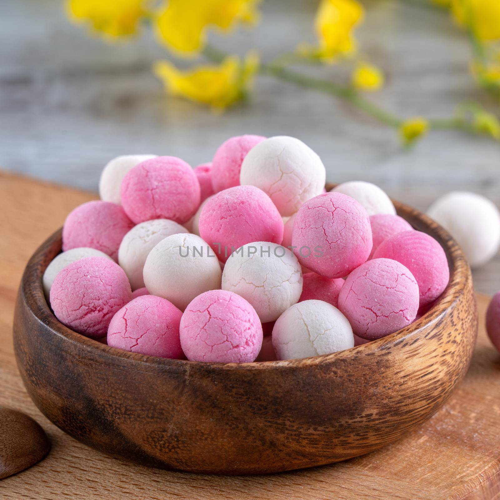 Raw red and white tangyuan glutinous rice dumpling balls on wooden table background for Winter solstice festival food.