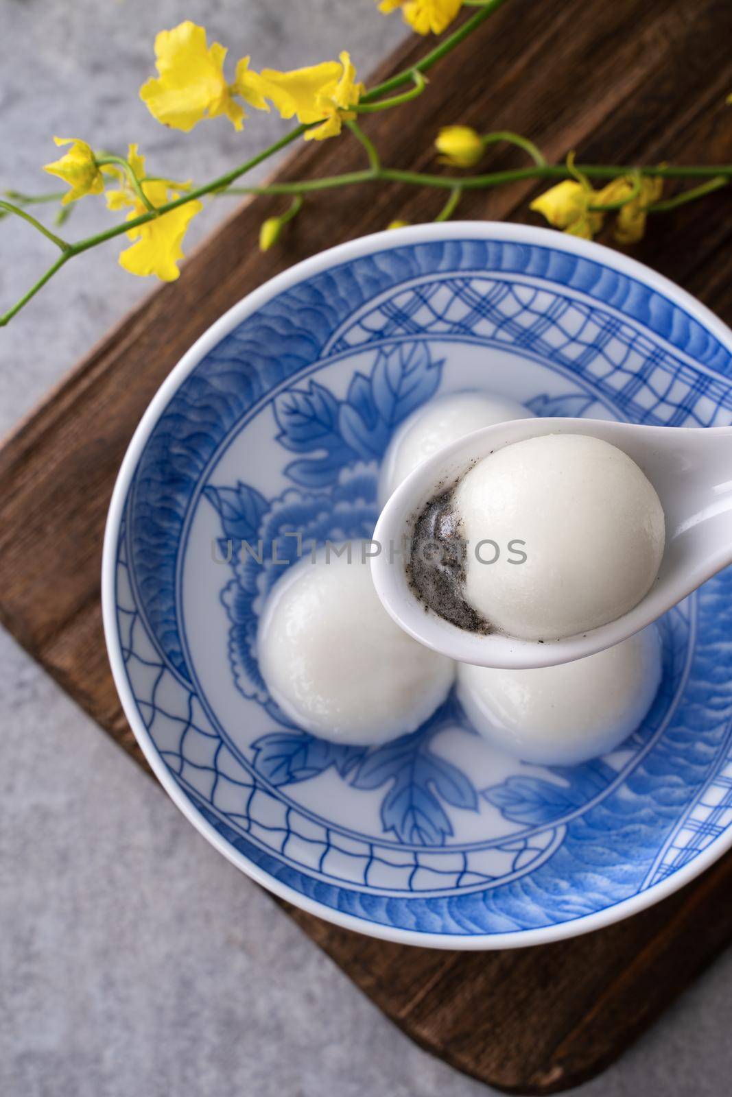 Top view of big tangyuan yuanxiao (glutinous rice dumpling balls) for lunar new year festival food, words on the golden coin means the Dynasty name it made.