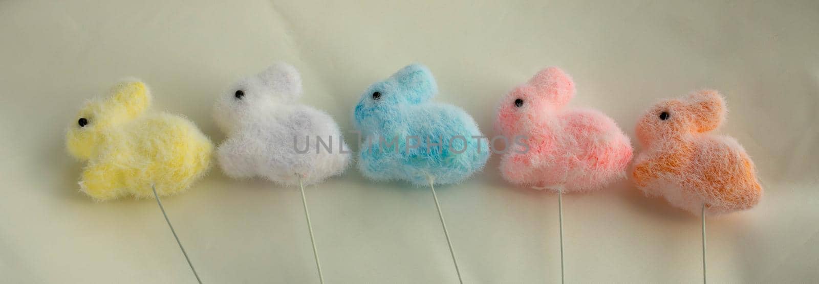 Yellow,white and pink, blue, orange Easter bunnies on a white background. Easter Concept.