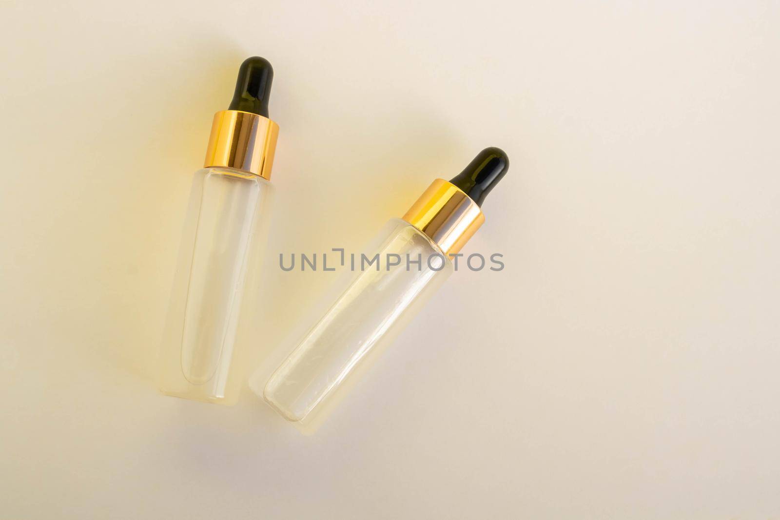 Two bottles of cosmetic liquid transparent gel on a white background. Flat styling style.