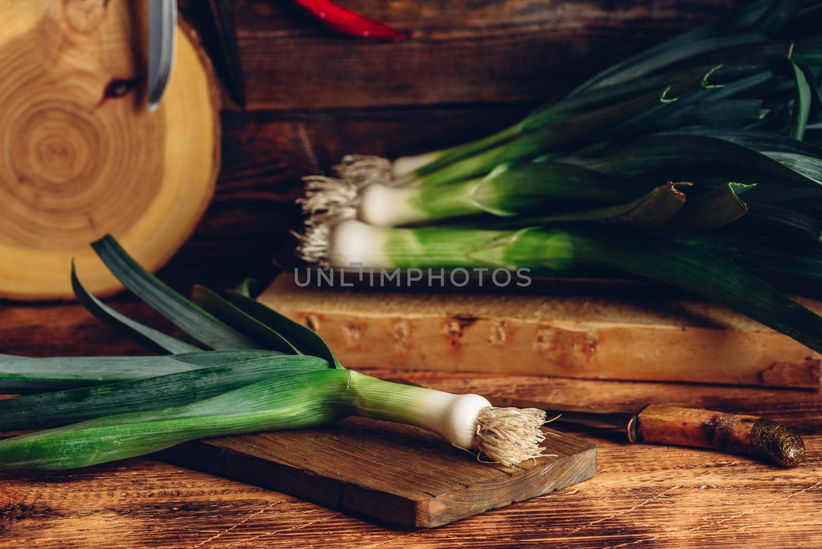 Fresh green leek on wooden cutting board